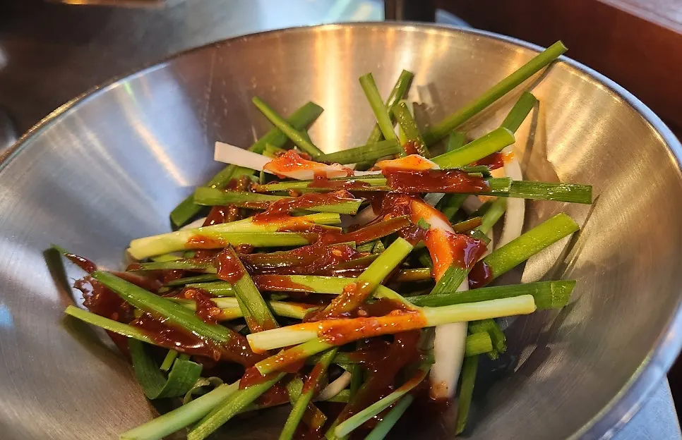 Meat wrap topped with chive salad