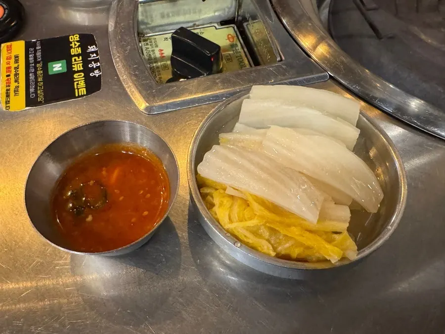 White kimchi and meat grilling on the pan