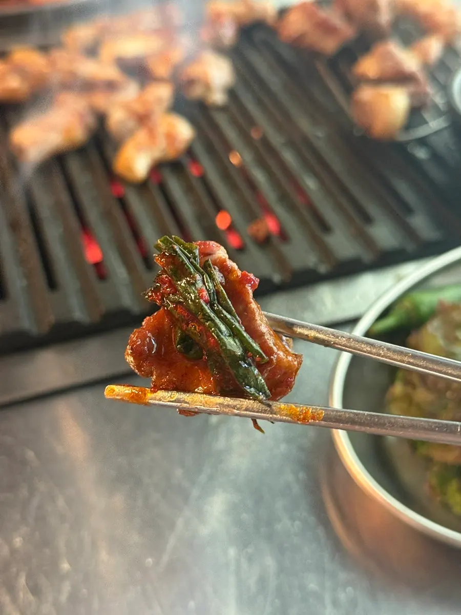 Staff grilling the first round of jumeok-gui