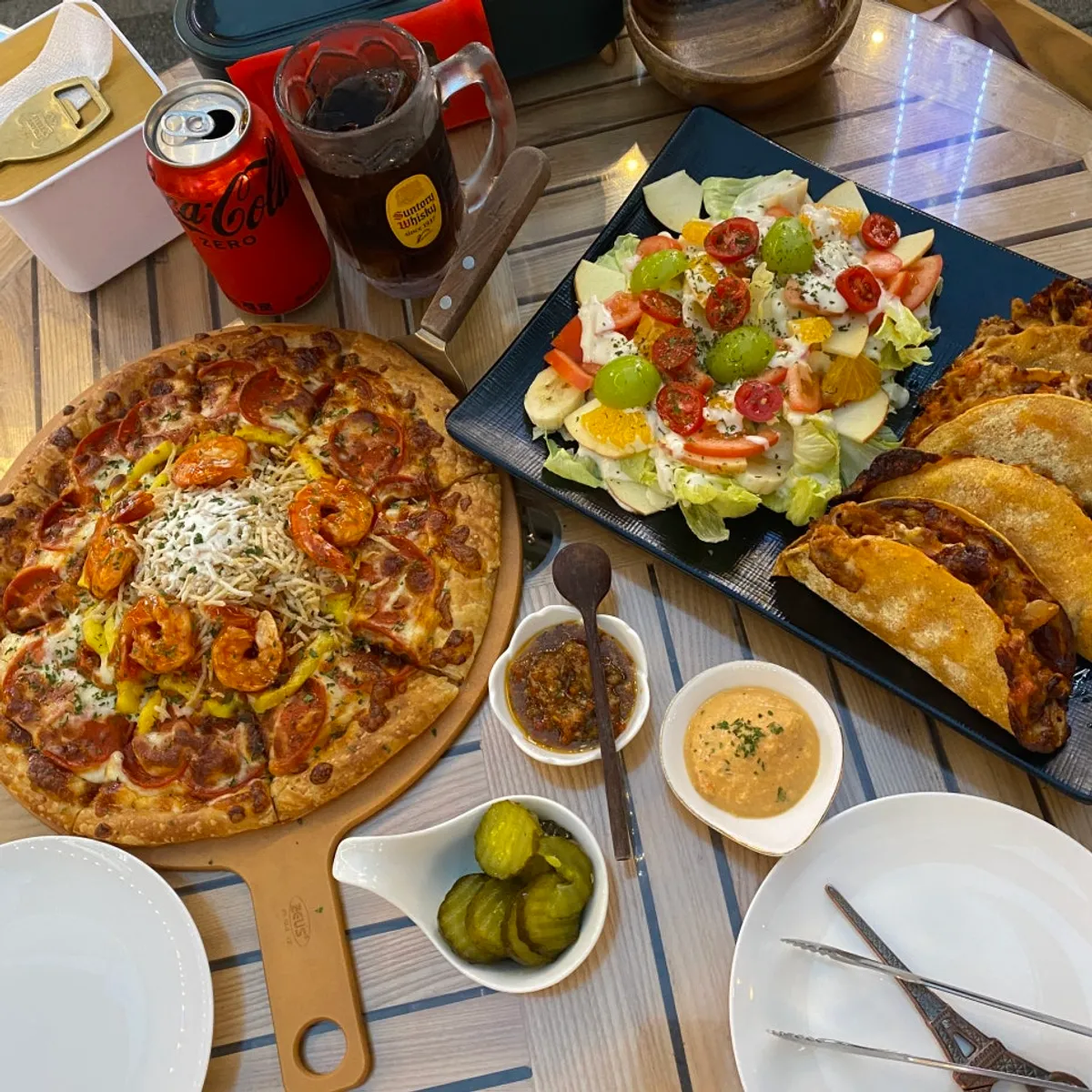 Table spread of Ambrosia pastry pizza and bulgogi taco at People & Peoples