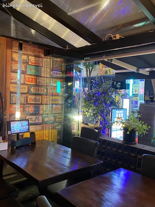 Interior of People & Peoples decorated with neon lights and wine bottles
