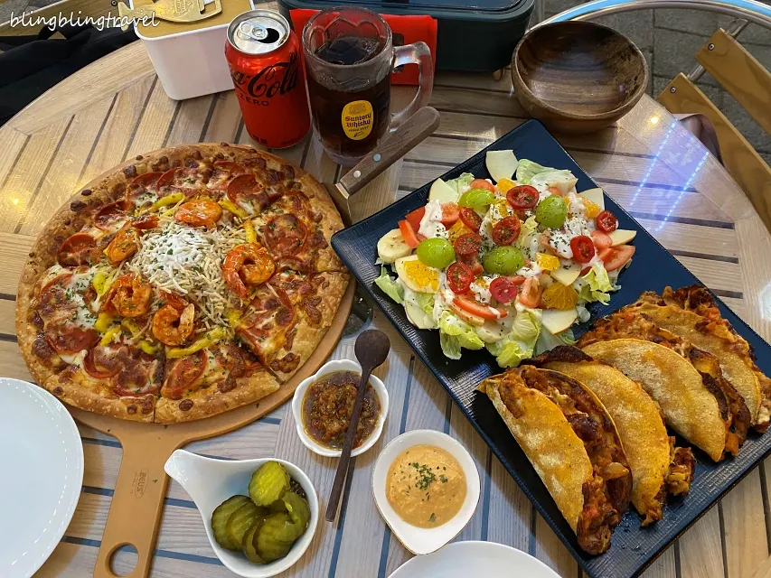 Full spread of Ambrosia pastry pizza and bulgogi taco fruit salad