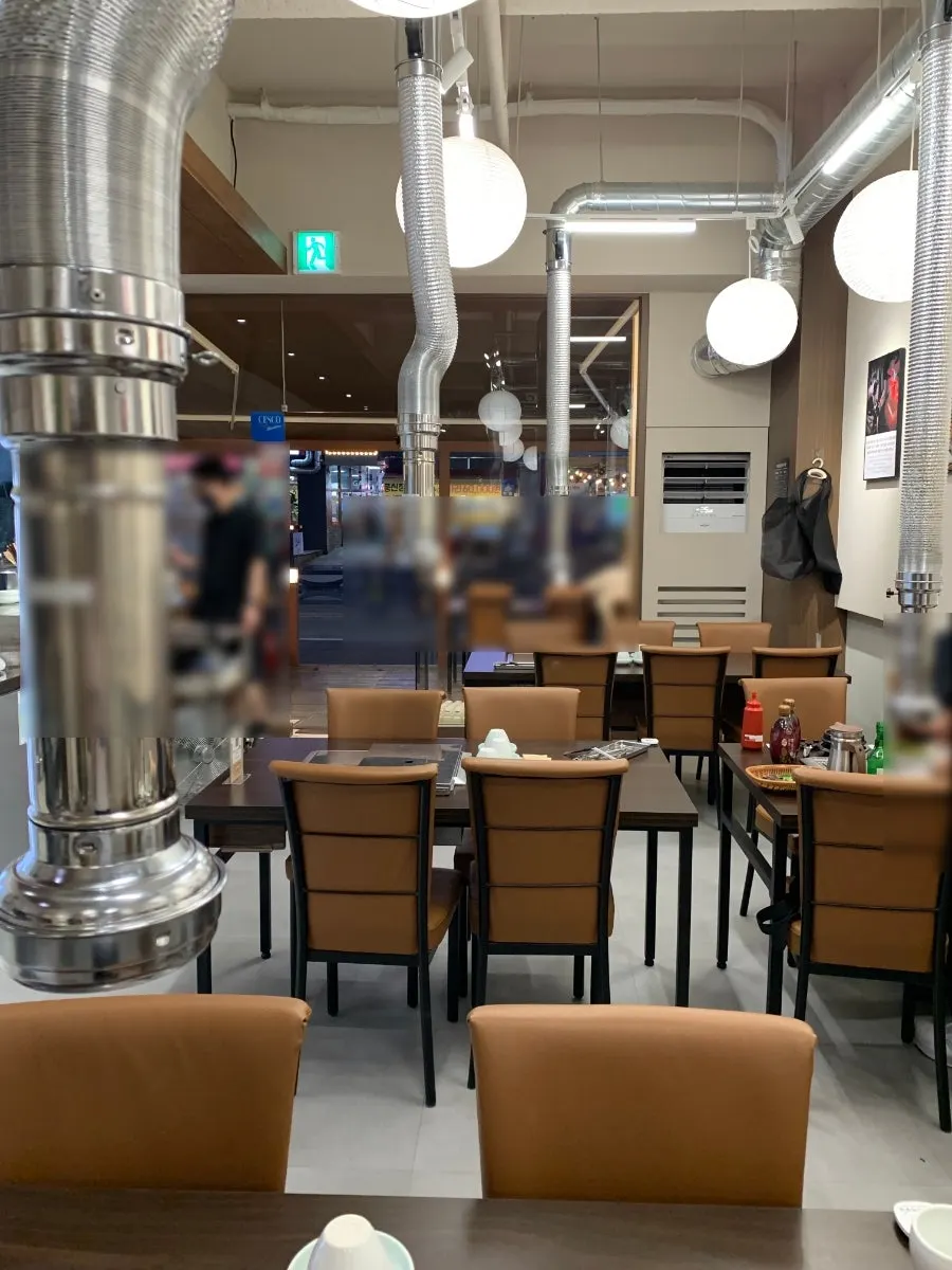 Stand of disposable aprons inside the restaurant