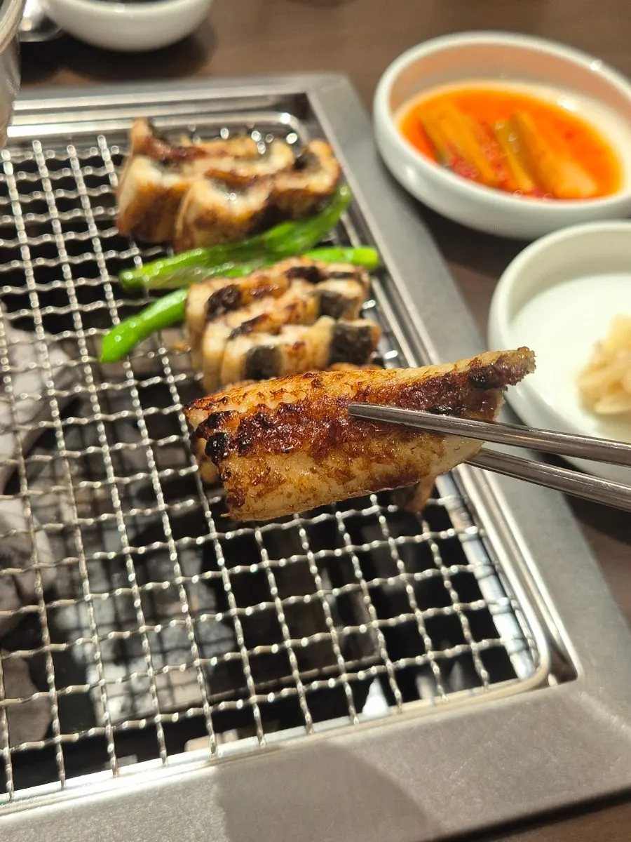 Chopsticks holding a piece of eel body meat