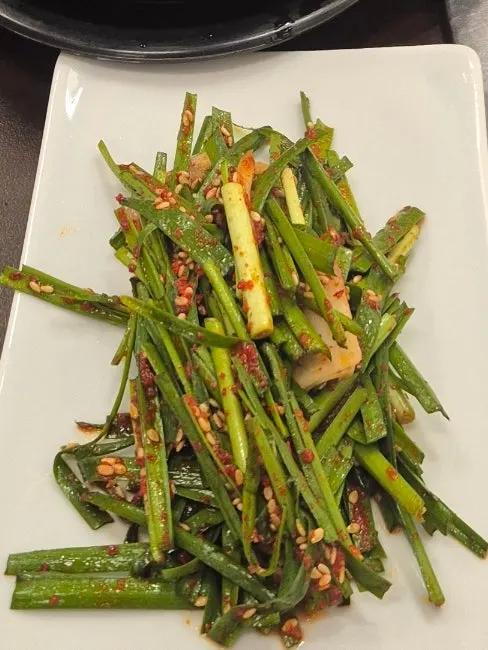 A piece of eel topped with julienned ginger