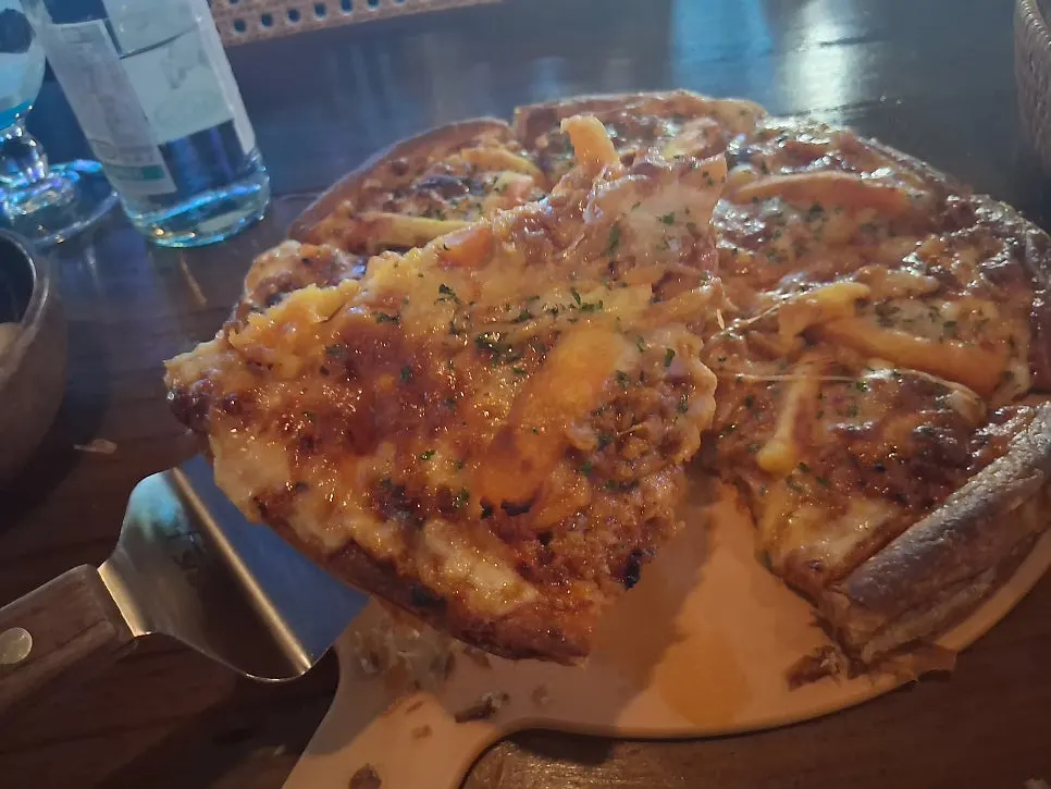 Pastry-dough pizza topped with cream cheese and ham