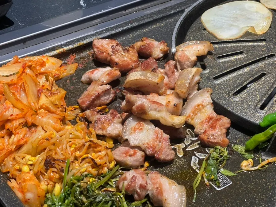 Staff cutting and grilling the meat