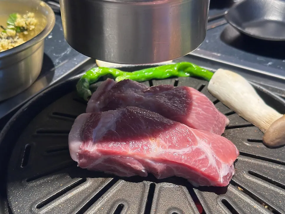 Minari, bean sprouts and kimchi grilling together on the pan
