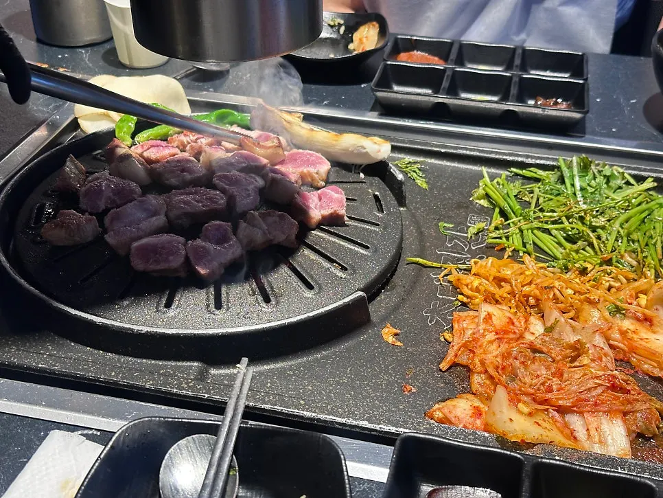 Staff member grilling the black pork