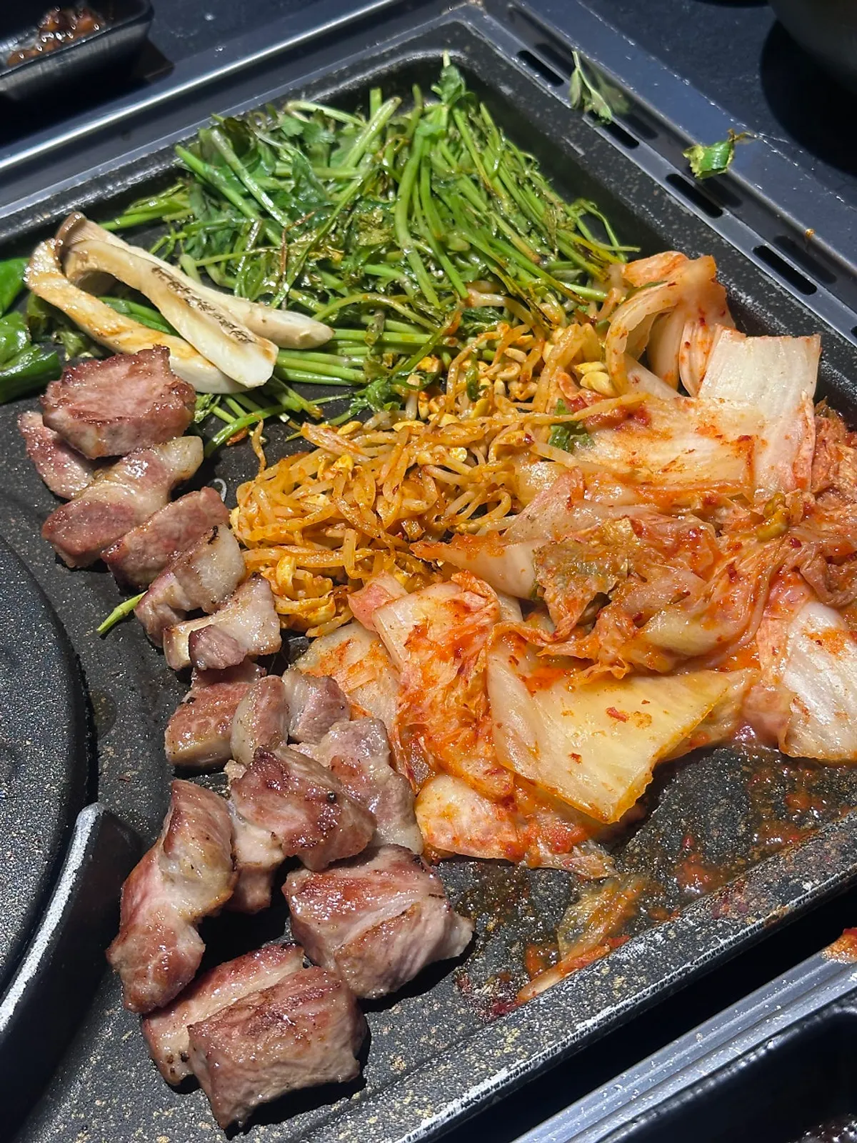 A grilled bite of meat with side dishes