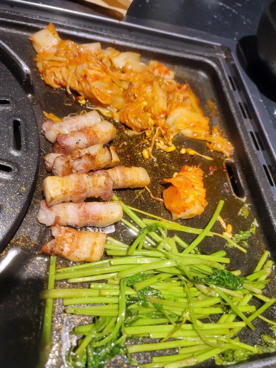 Pork belly served with minari and green onion salad