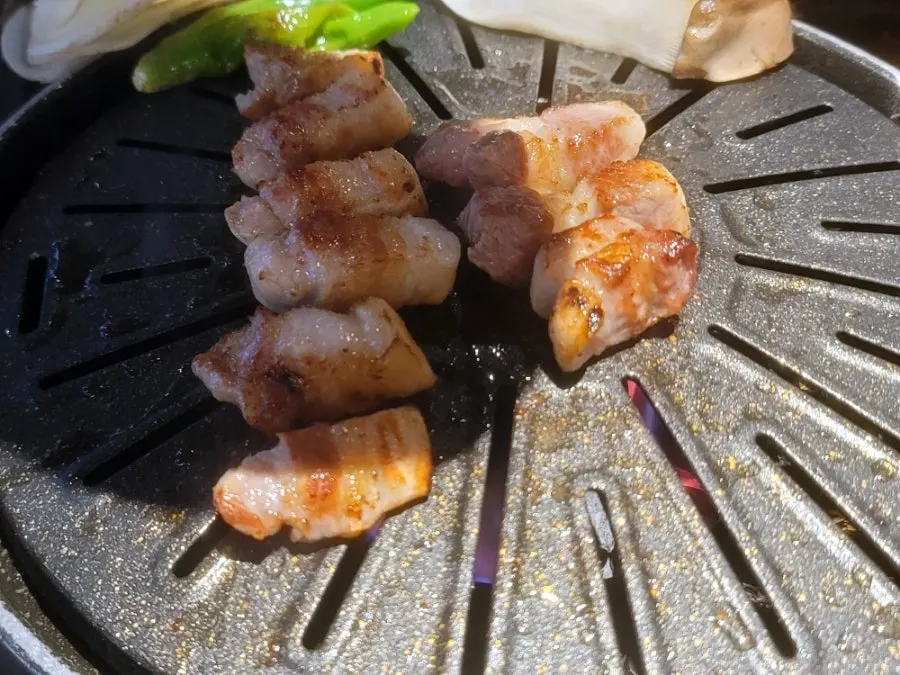 Table setting with pork belly and lettuce wraps