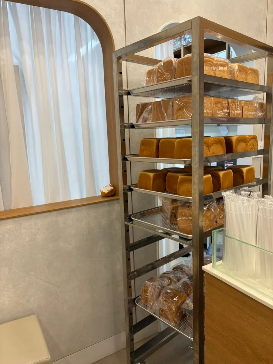 Store interior with tables and bread-shaped cushions and dolls