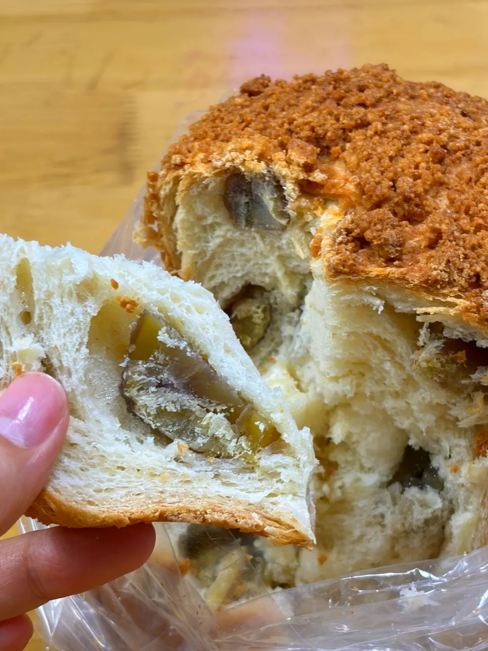A partly eaten piece of soboro chestnut rice cake milk bread