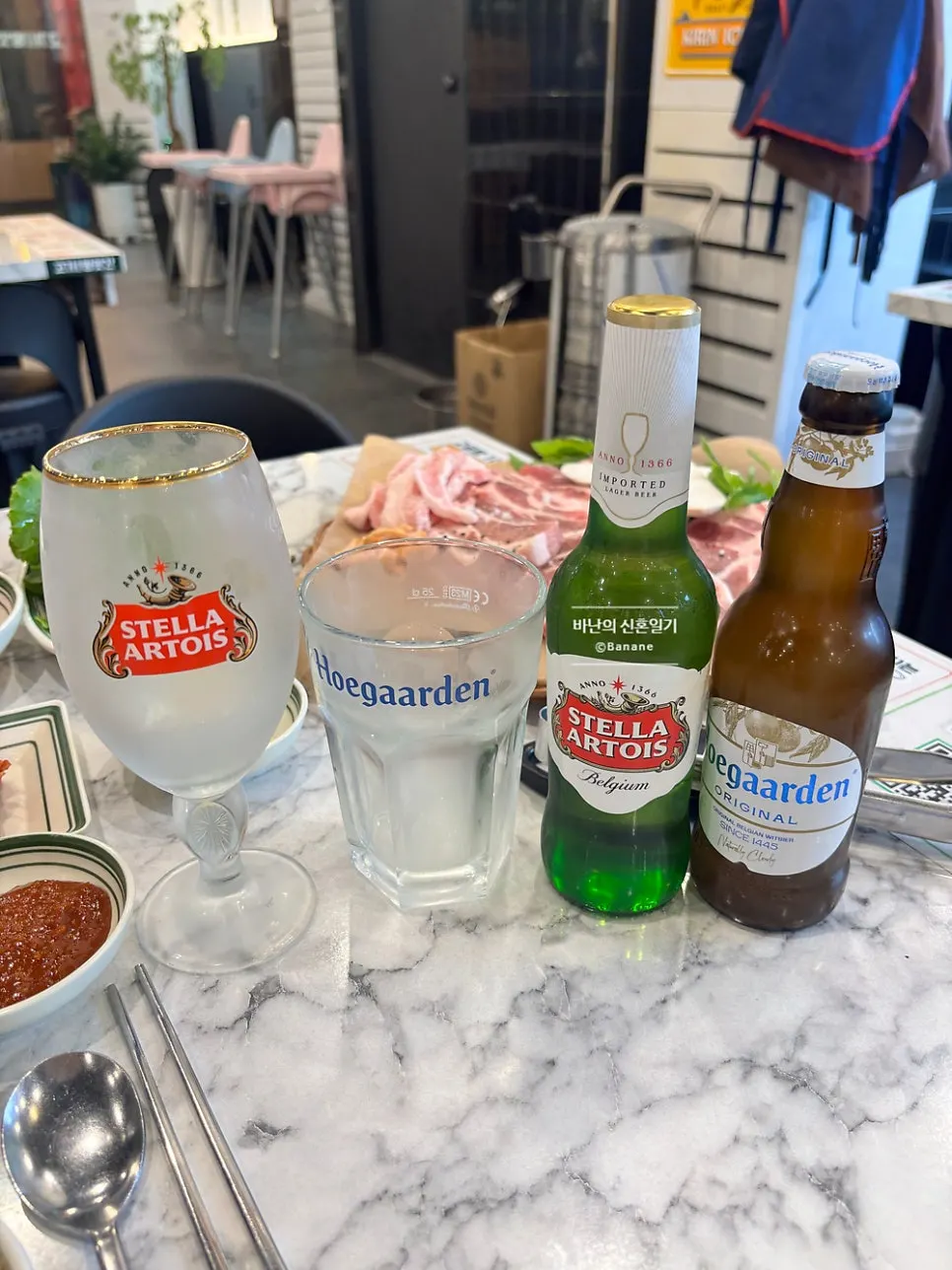 Two glasses of Stella and Hoegaarden beer