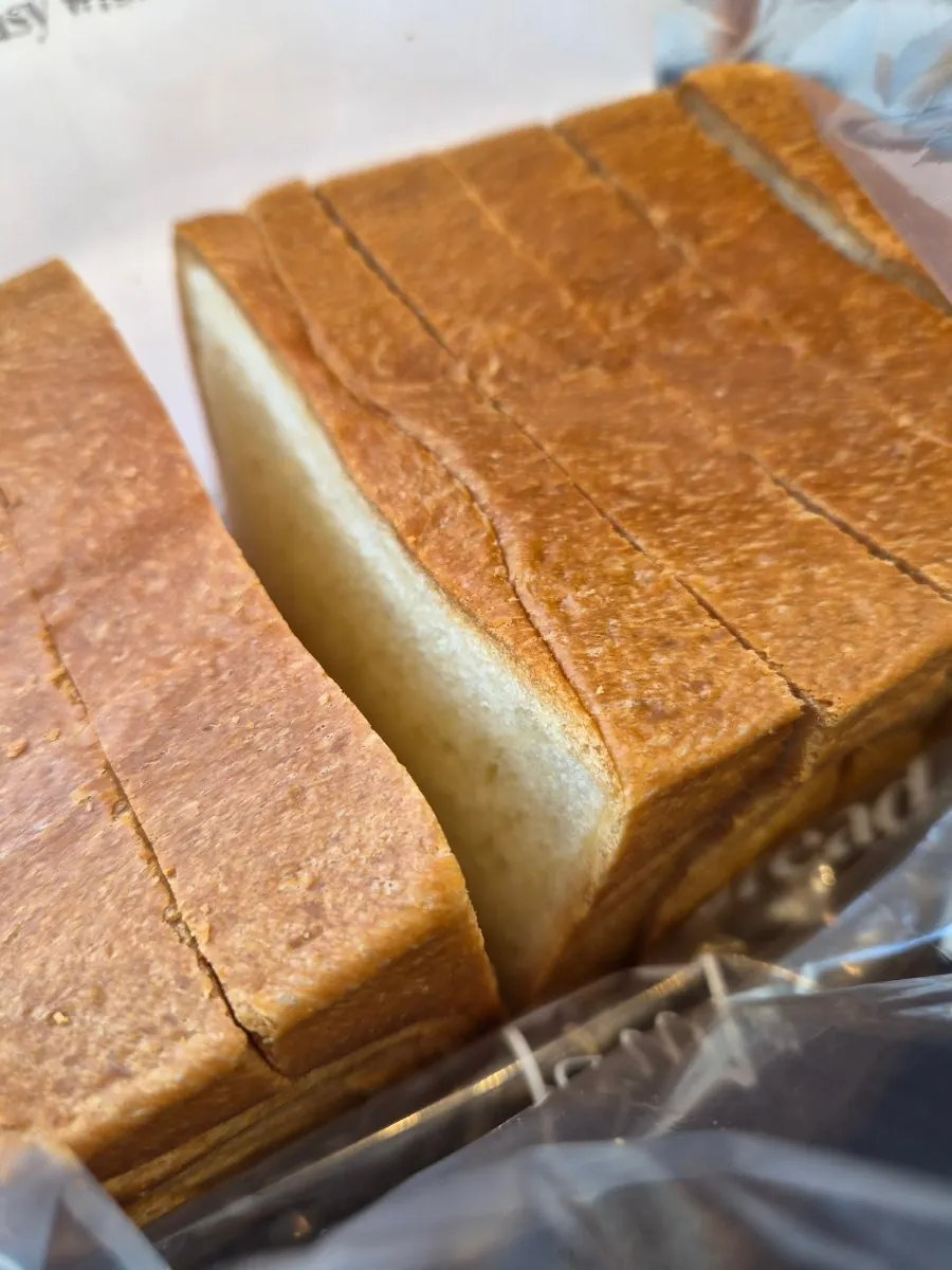 A piece of milk bread torn off and eaten plain
