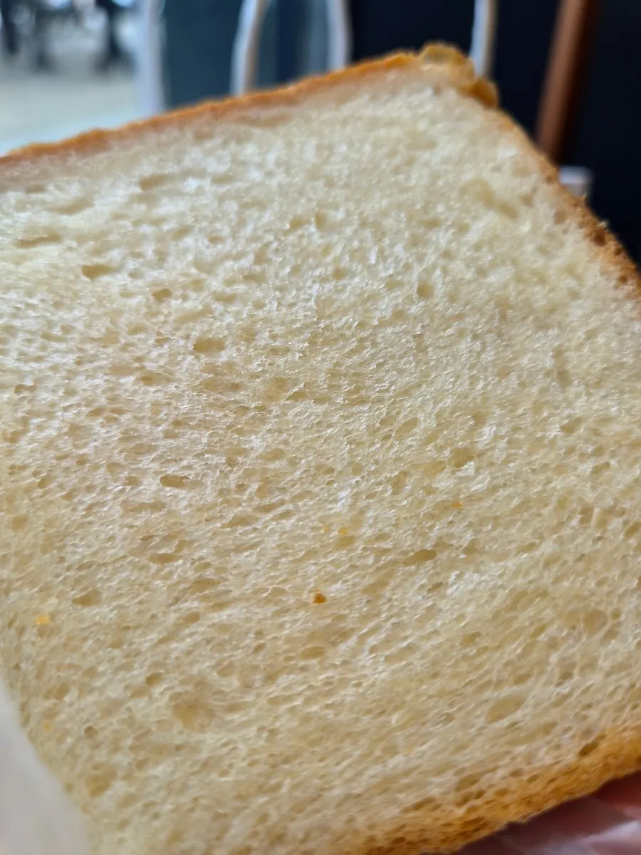 A slice of milk bread with noticeable buttery flavor