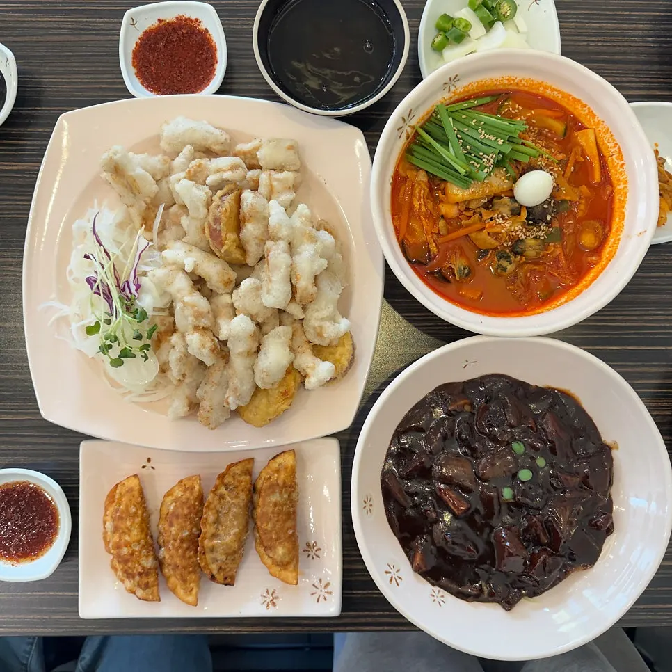 A full spread of jjamppong, jjajang and sweet and sour pork on the table