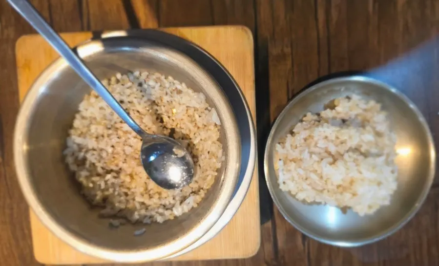 A spoonful of rice topped with seasoned vegetables