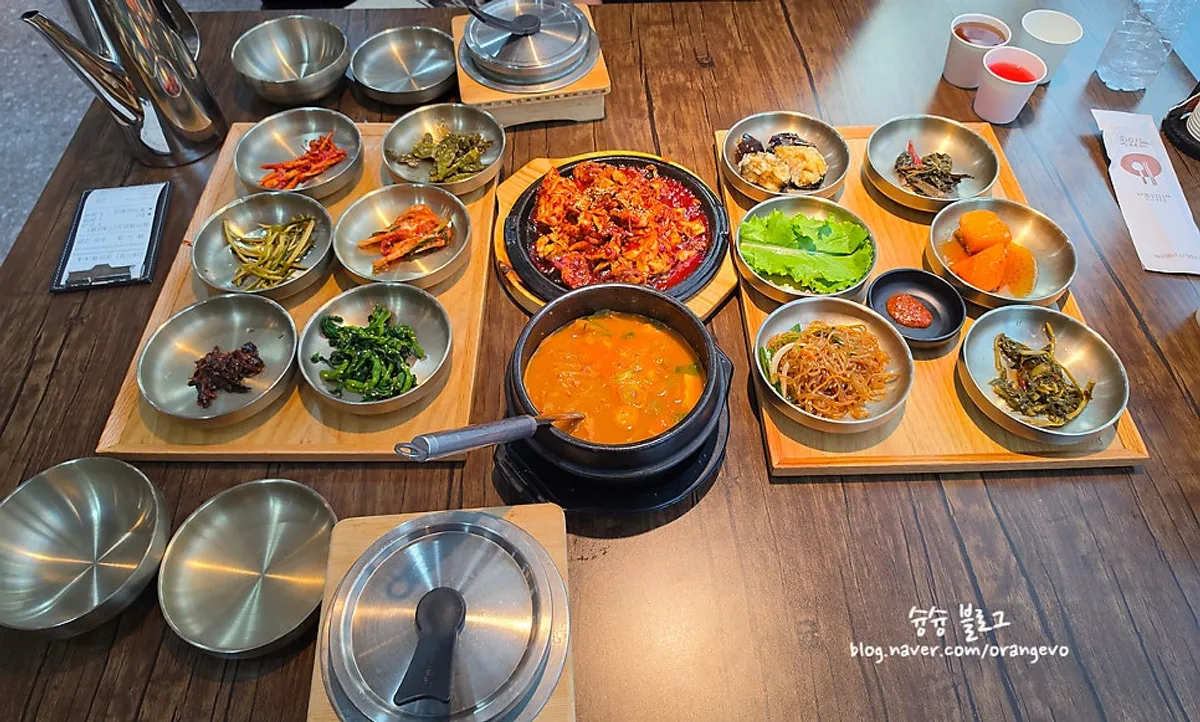 Tteuranchae bapsang table spread with 12 side dishes, cheonggukjang and pot rice