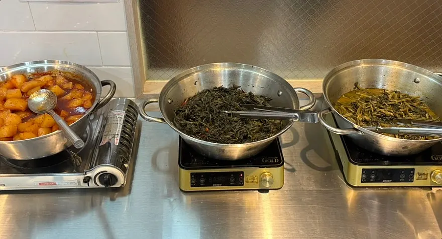 Braised potatoes and namul dishes at the self-serve bar