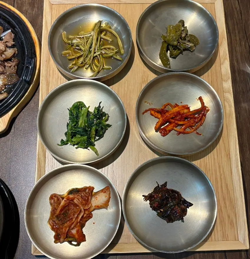 Seasonal side dishes including fried eggplant, japchae, and braised potatoes