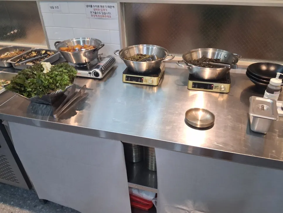 Self-bar of side dishes set up at the center of the restaurant