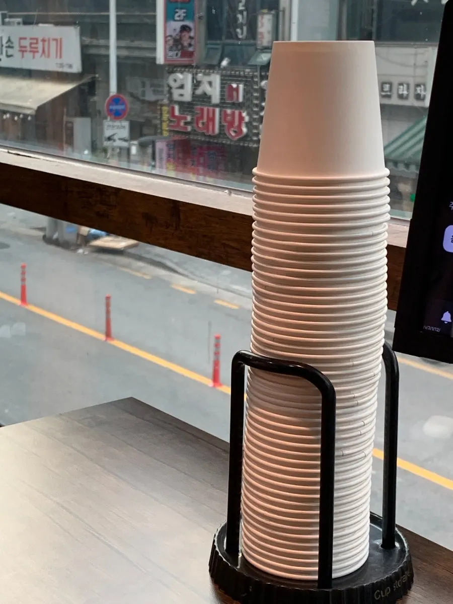 Cold water and paper cups prepared at the table