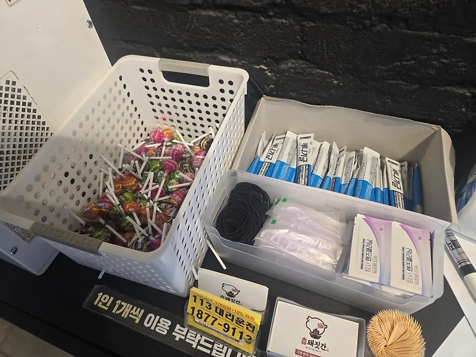 A corner of the self-serve bar with plates, scissors, and tongs