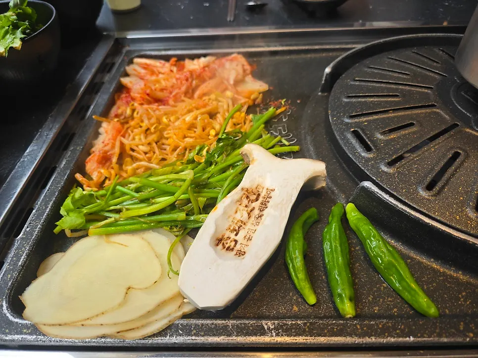 Meat and sliced potatoes on the grill