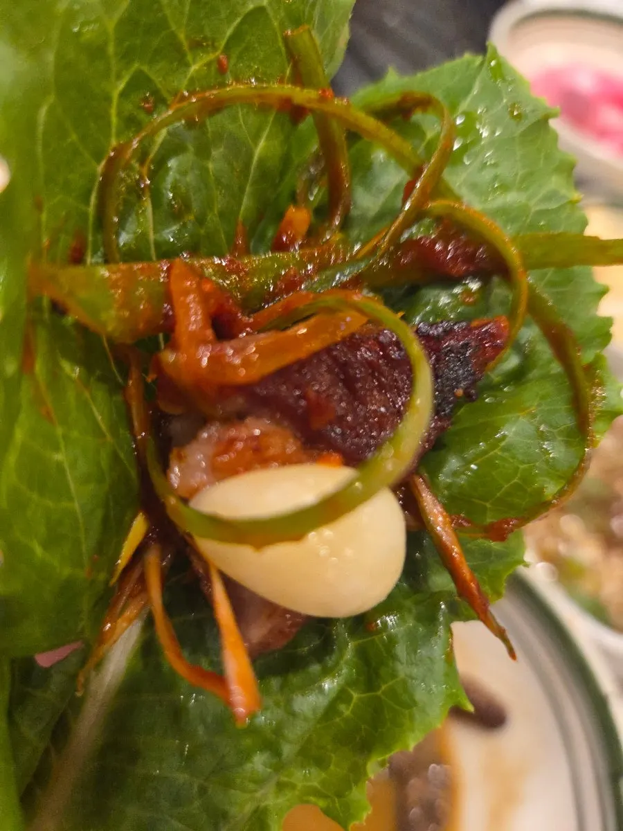A grilled piece of meat dipped in the special sauce