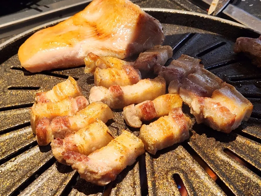 Thick pork grilled by a staff member