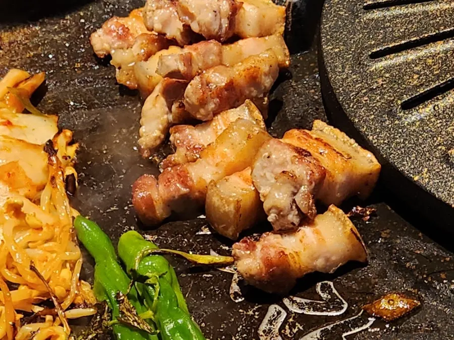 Ogyeopsal turning golden on the grill