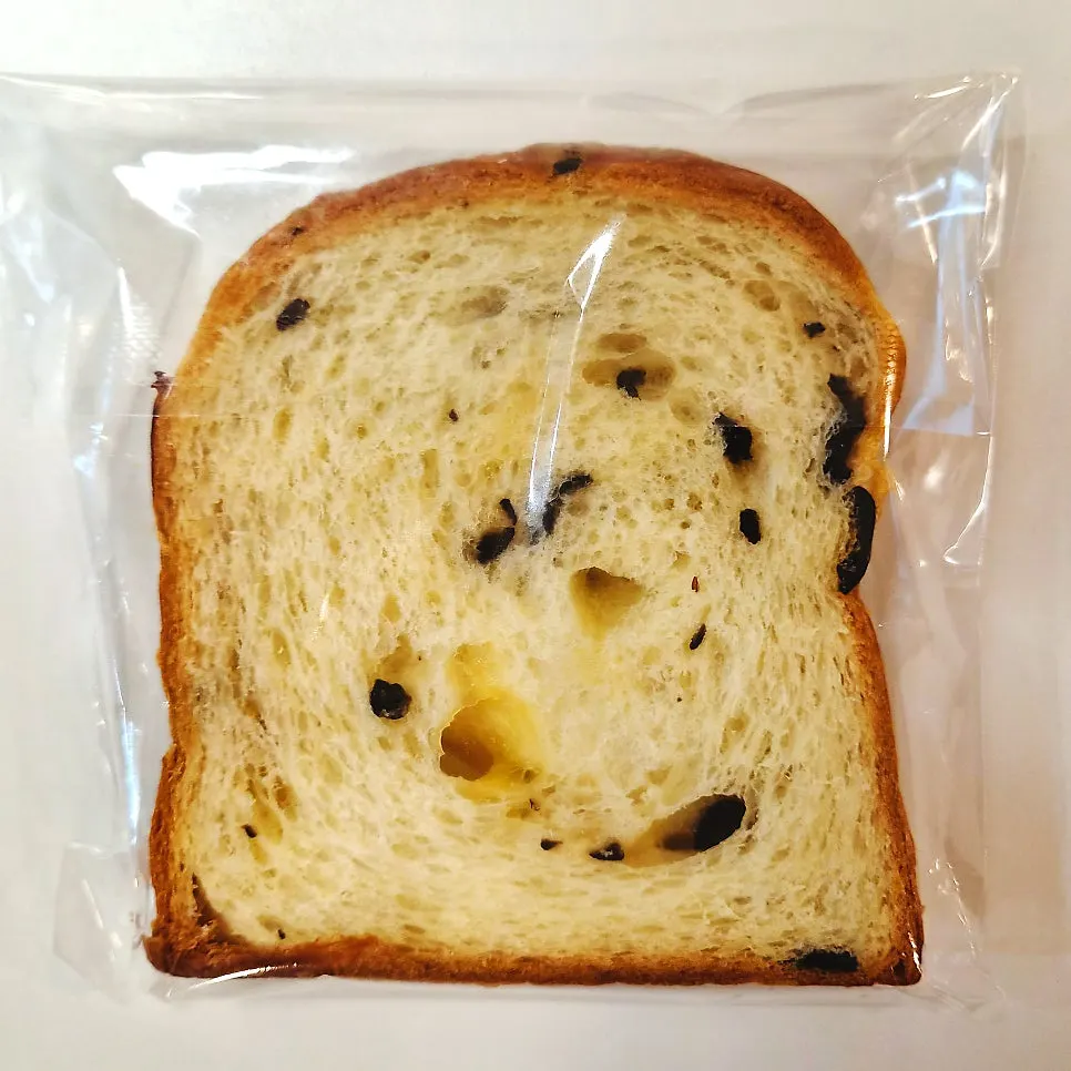 Inside of olive cheese milk bread with slightly melted cheese