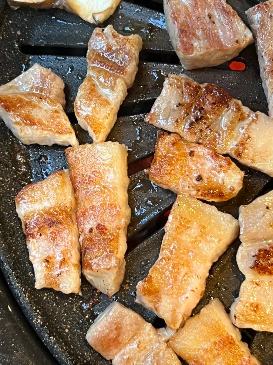 Aged meat cooking on the grill