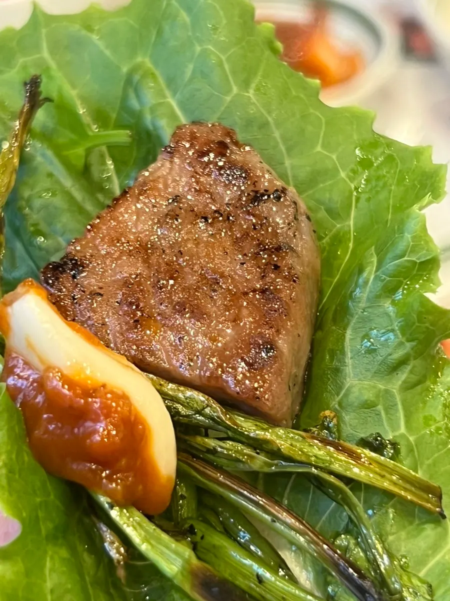 A piece of pork neck dipped in salt