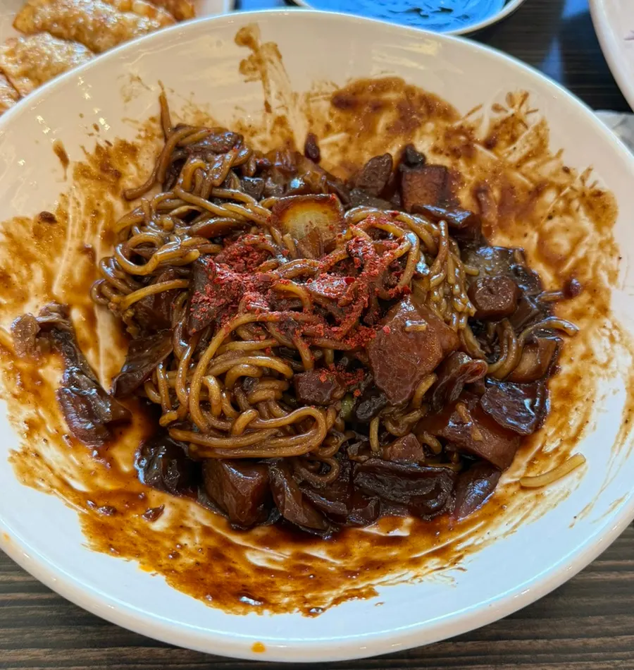 Jijon jjajang mixed with chili flakes sprinkled on top