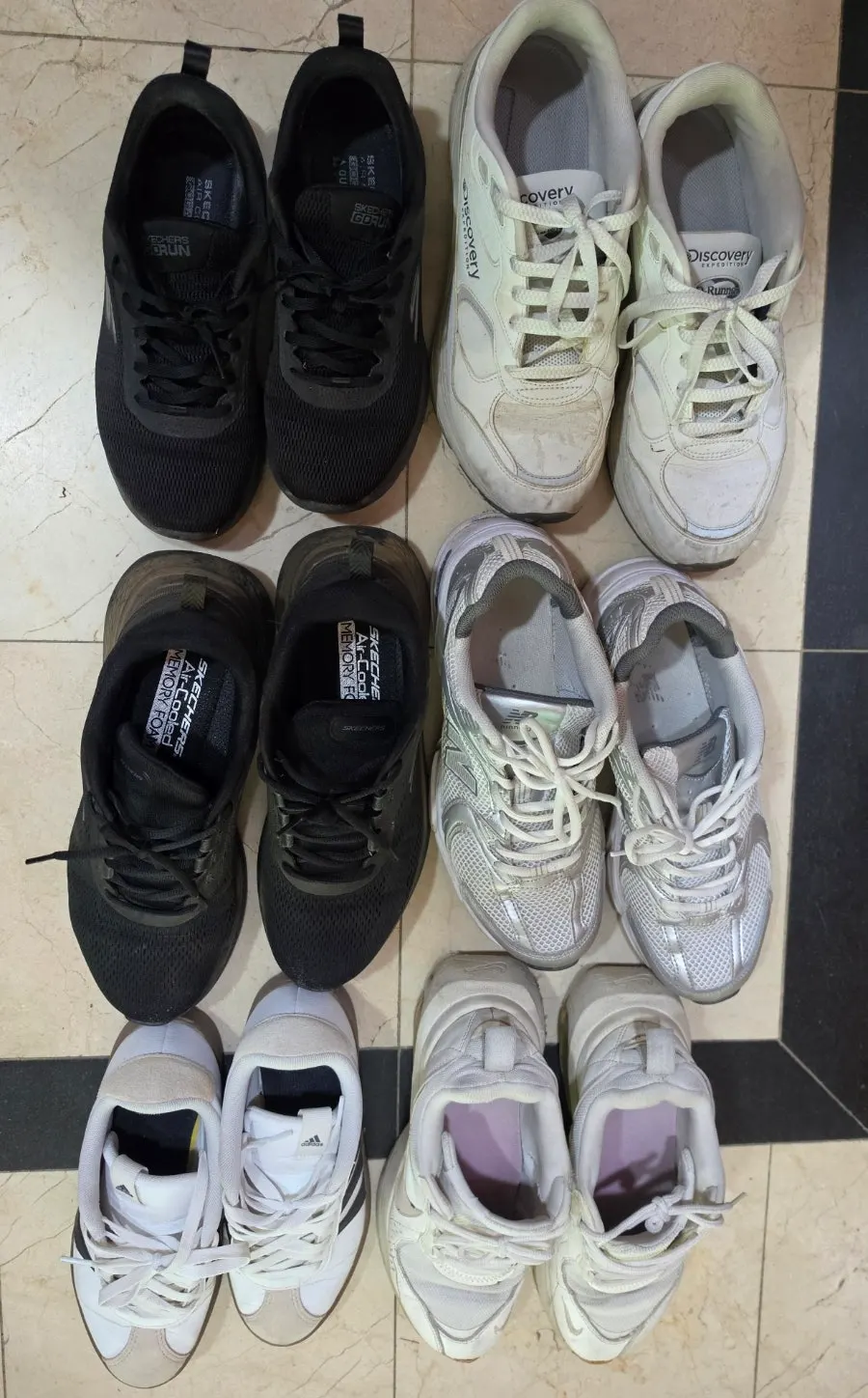 Owner cleaning debris off a customer's sneakers