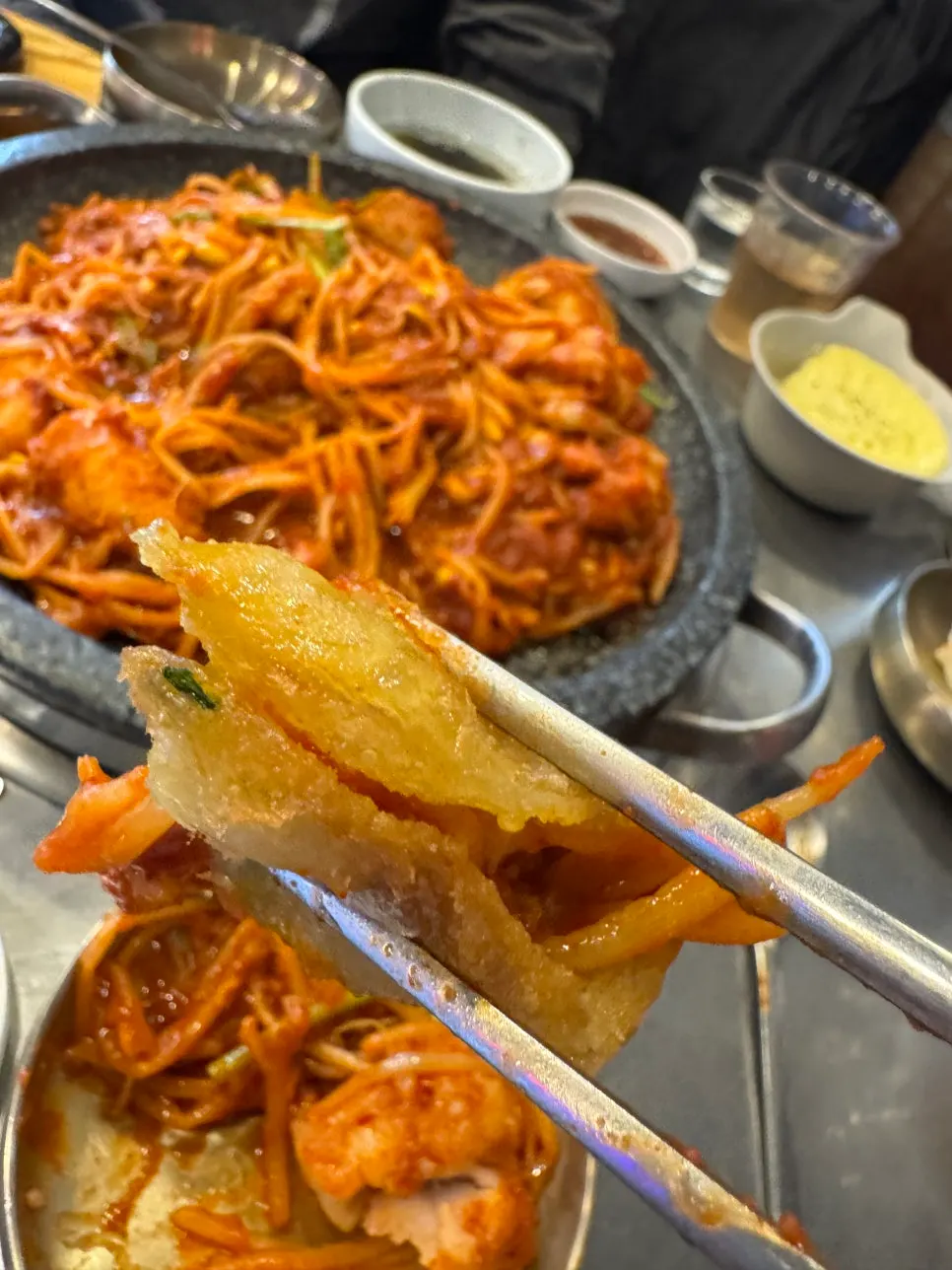 Placing agujjim onto a dumpling to wrap it