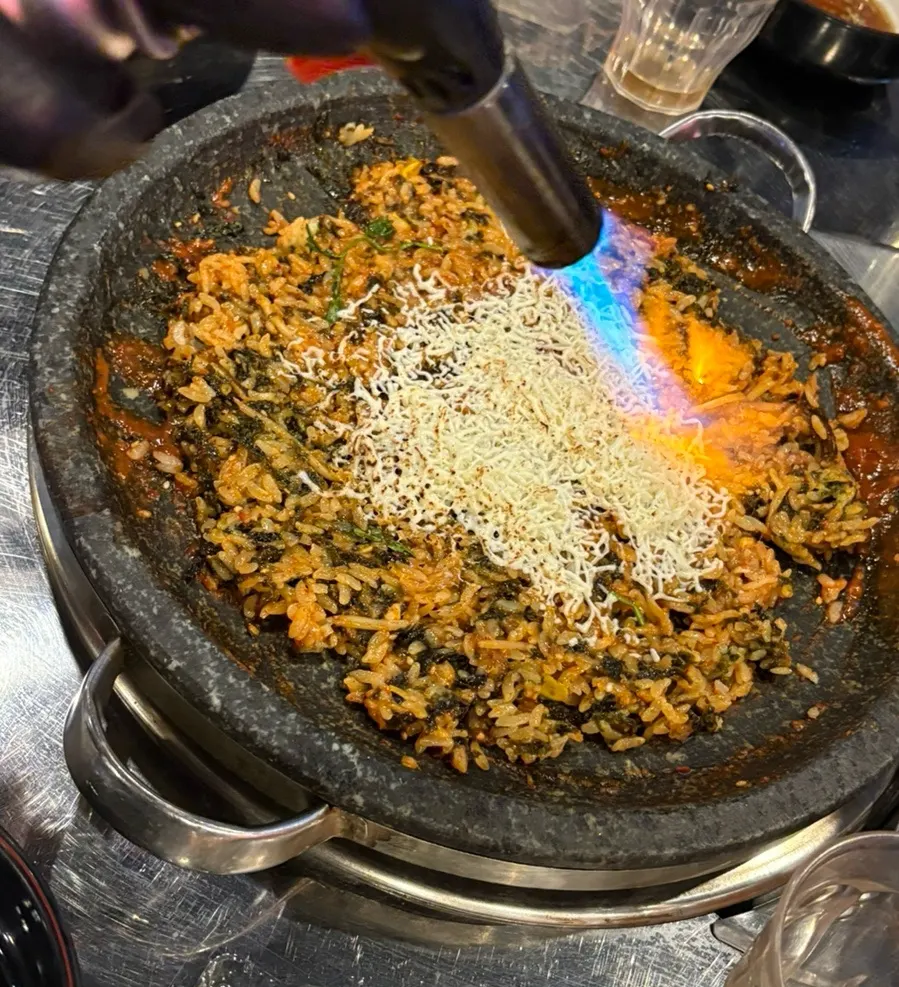 Torching cheese onto the fried rice