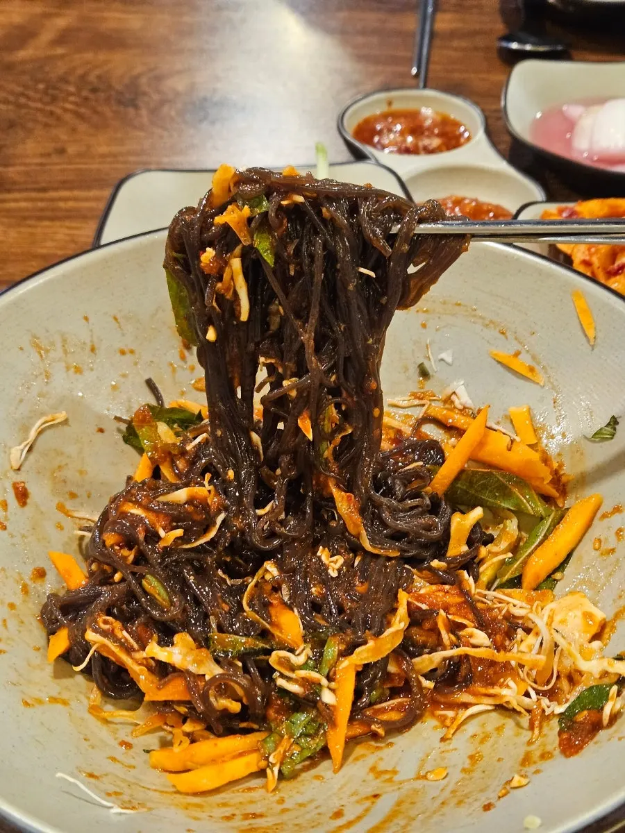 Makguksu noodles mixed in fruit sauce