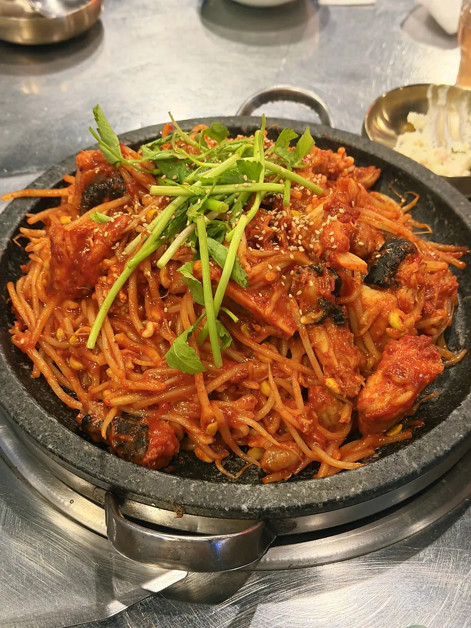 Hot plate seafood monkfish stew piled high on the stone plate