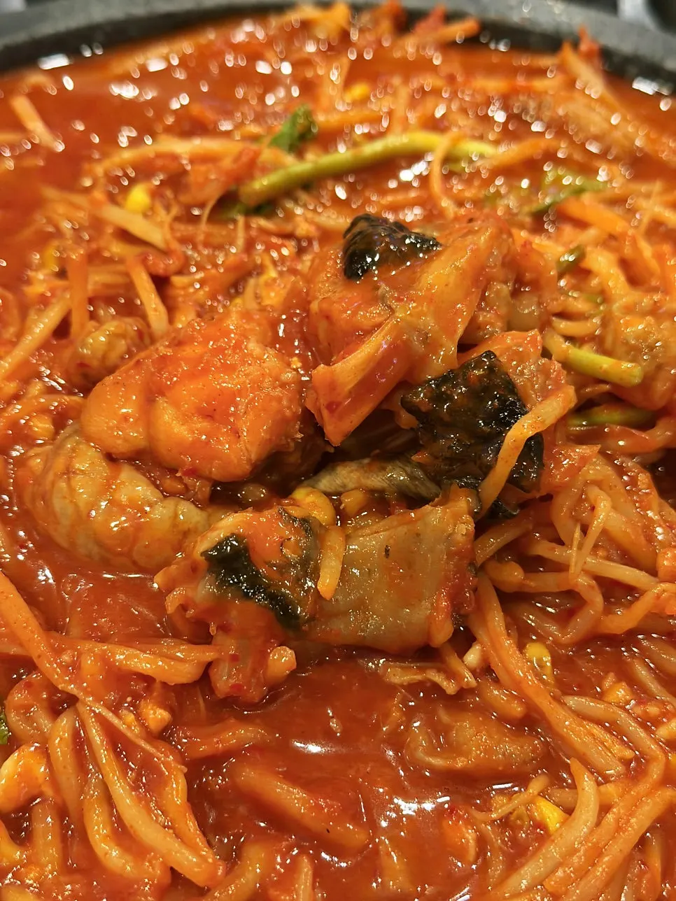 A large chunk of monkfish meat picked up with chopsticks