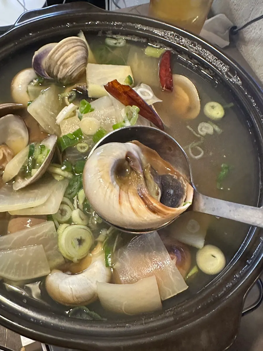 Pot of whole whelk stew with clams and whole whelk