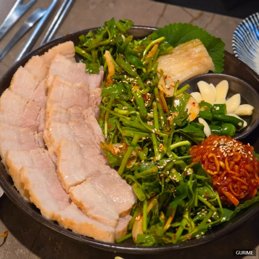 Buchigom bossam topped with minari