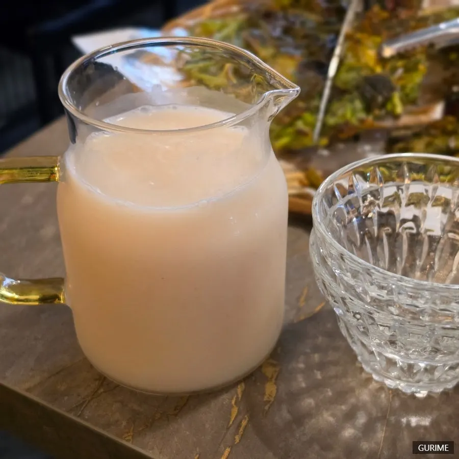 Signature Buchigom makgeolli served in a water bottle