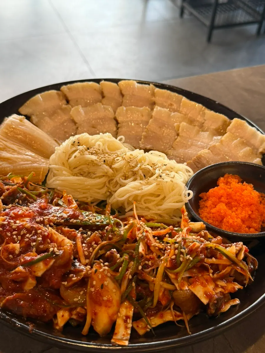 Bossam and gulbaengi somyeon plated in the Buchigom set menu