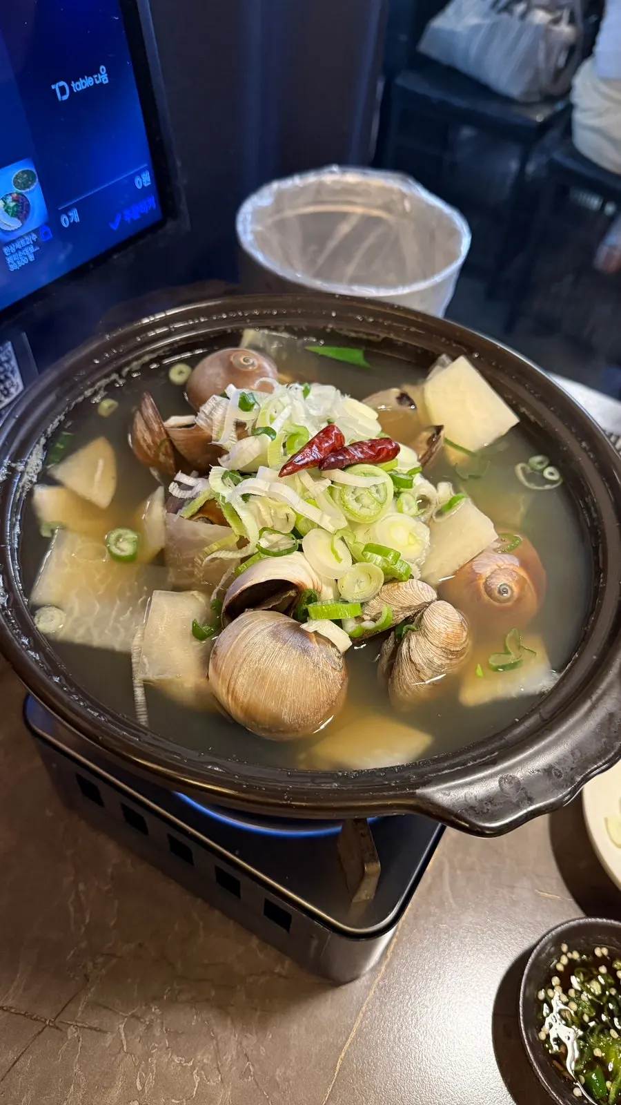 Pot of whelk stew filled with whole whelks