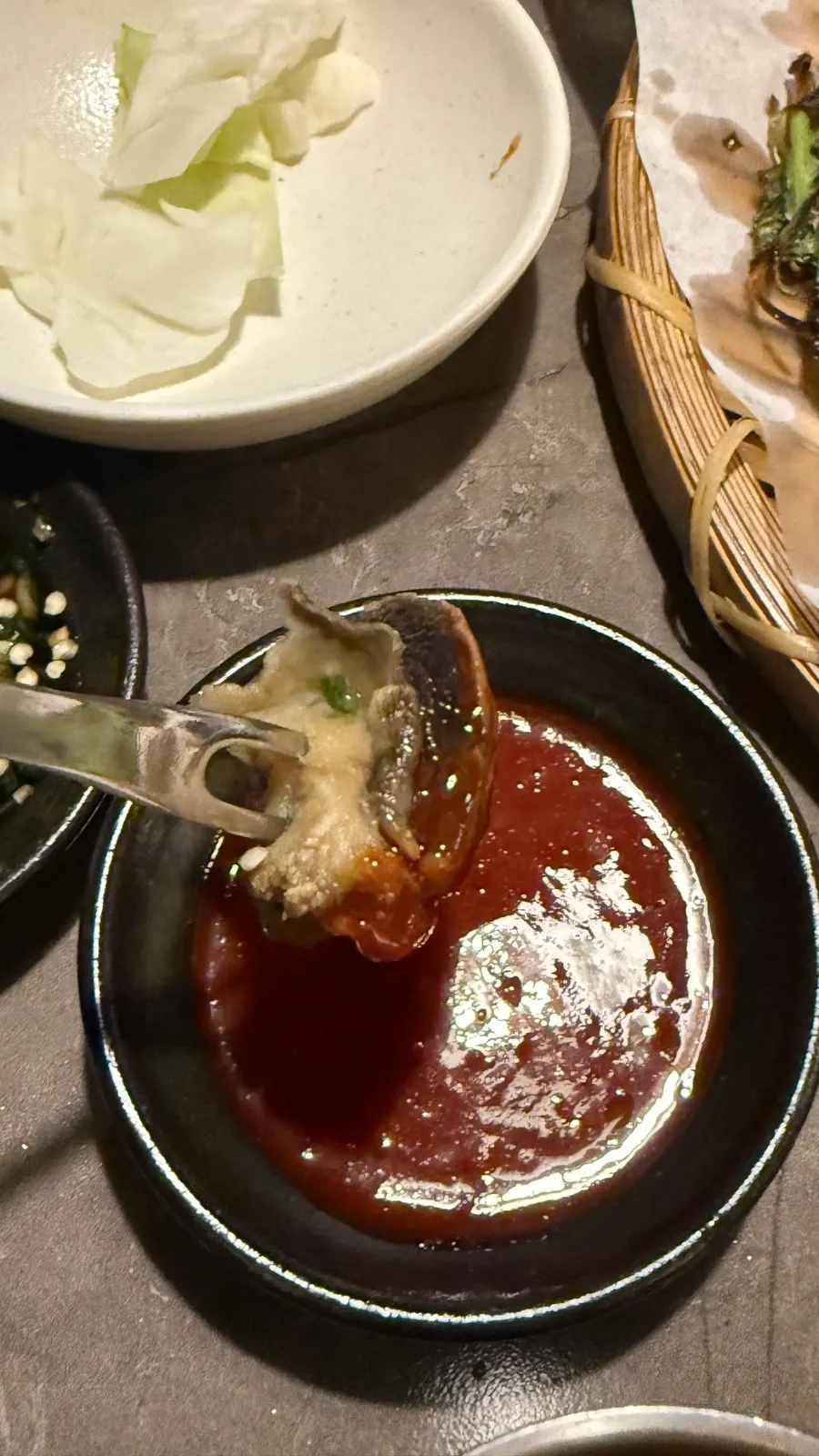 A bowl of whelk stew enjoyed as a soup-based snack