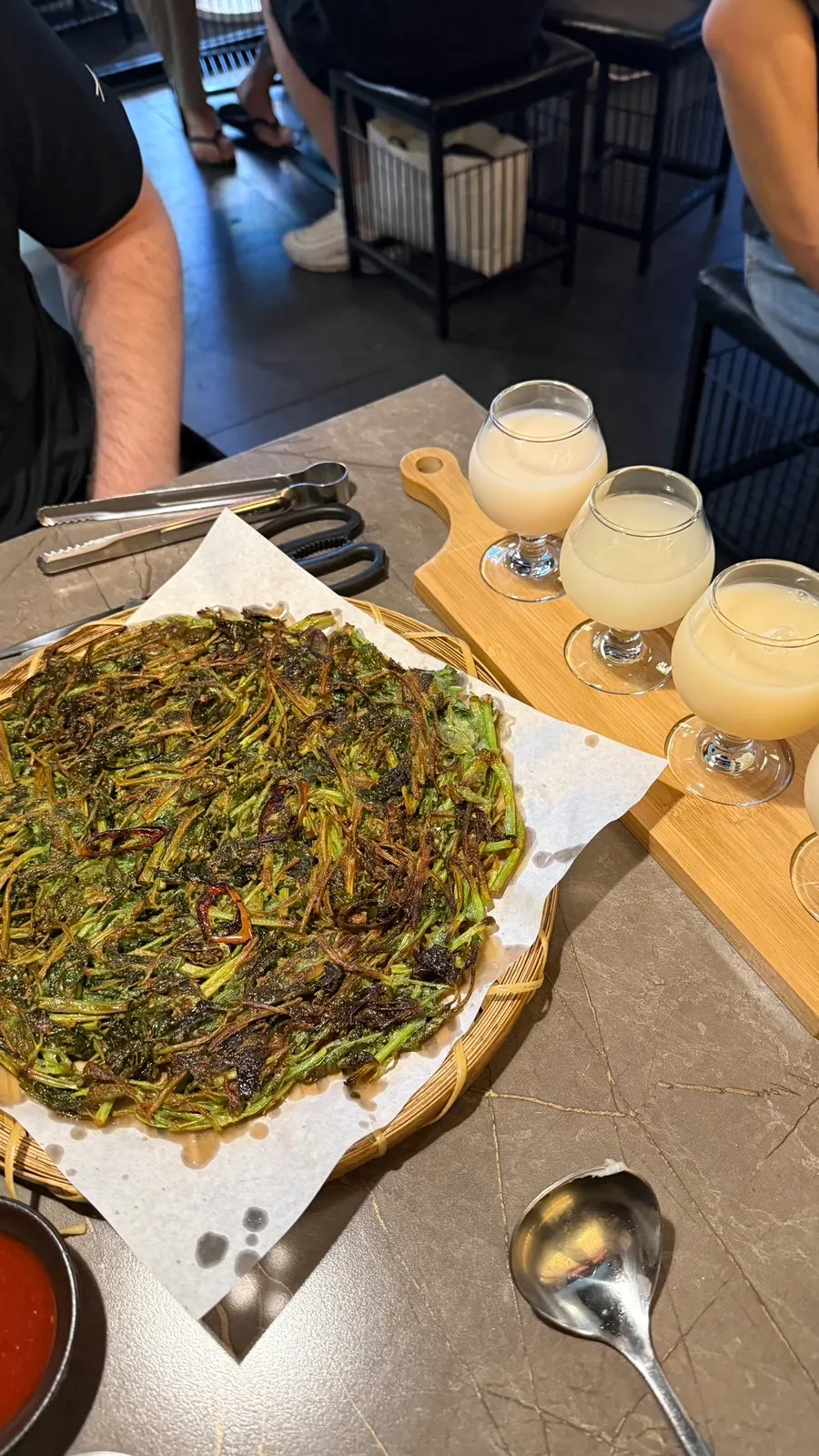 Four different makgeolli poured into individual glasses